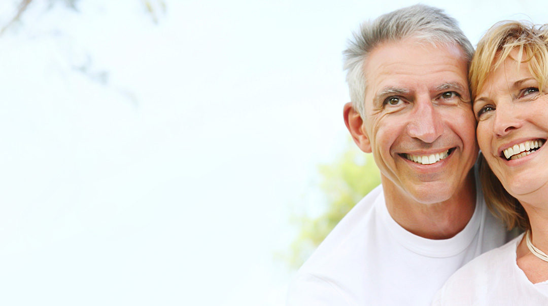 Smiling senior couple embracing outdoors