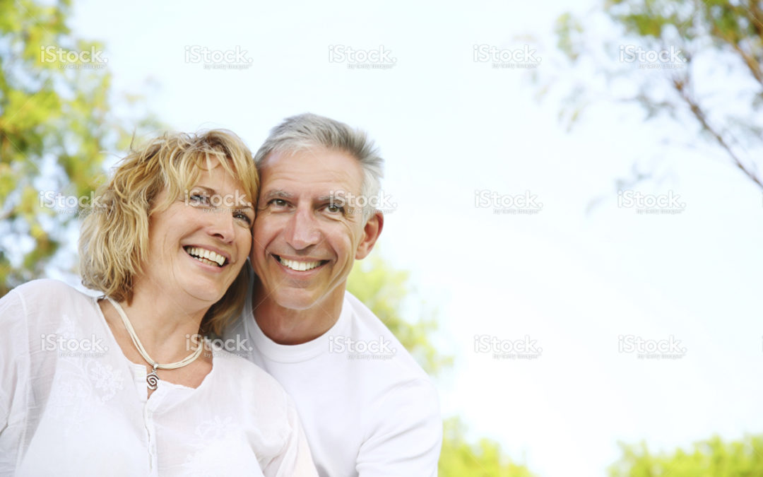 Happy senior couple smiling outdoors in park