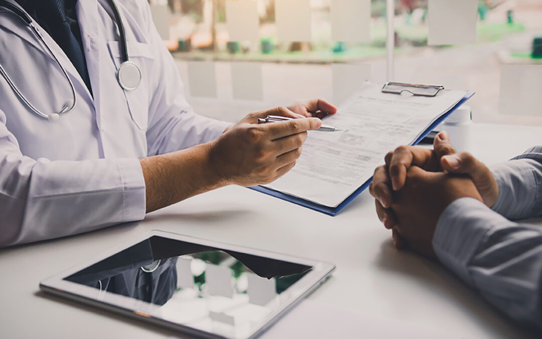 Doctor reviewing medical forms with patient